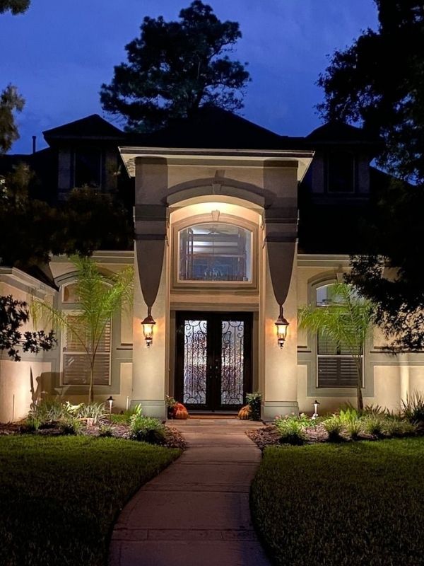 A residential home with outdoor lighting.