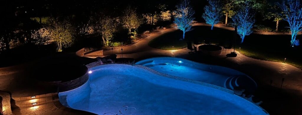 A beautiful residential pool highlighted by gorgeous outdoor lighting. 